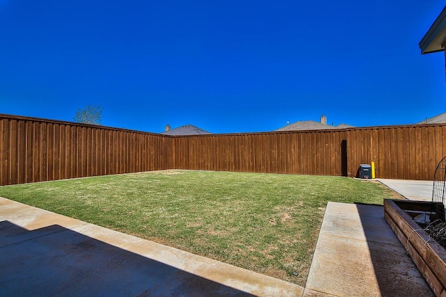 view of yard featuring a patio and a fenced backyard