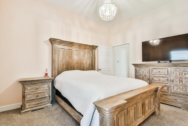 bedroom with baseboards, carpet floors, and an inviting chandelier