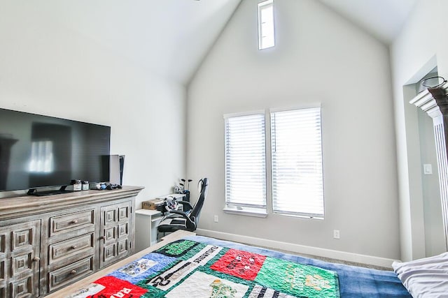 bedroom with high vaulted ceiling, multiple windows, and baseboards