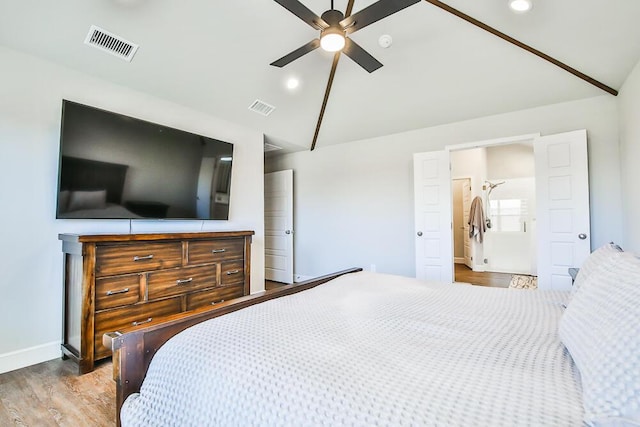 bedroom with lofted ceiling, wood finished floors, visible vents, and recessed lighting