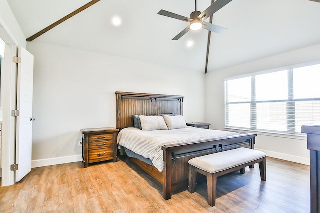 bedroom with a ceiling fan, baseboards, vaulted ceiling with beams, and light wood finished floors