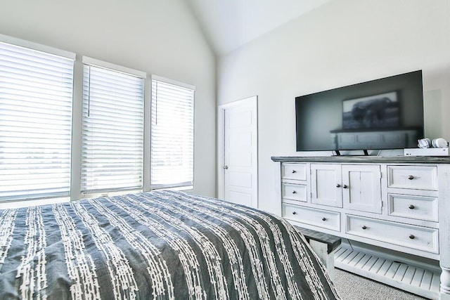 bedroom featuring vaulted ceiling and carpet