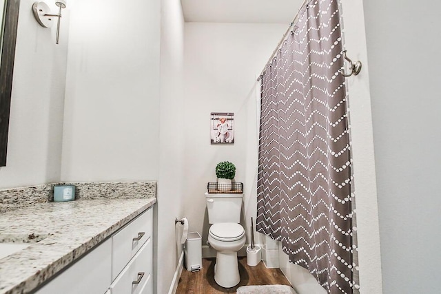 full bath with toilet, wood finished floors, vanity, baseboards, and a shower with curtain