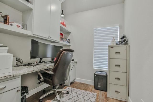 office featuring light wood-type flooring and baseboards