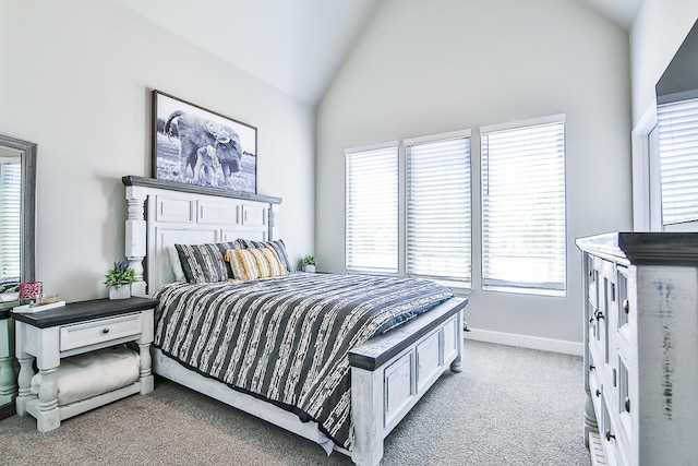 bedroom featuring vaulted ceiling, baseboards, and light colored carpet