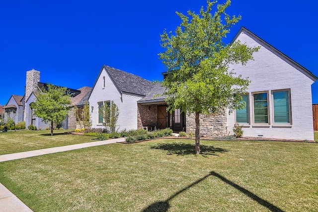 view of front of home featuring a front lawn and brick siding