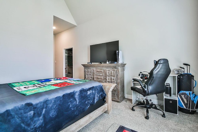 carpeted bedroom featuring lofted ceiling and baseboards