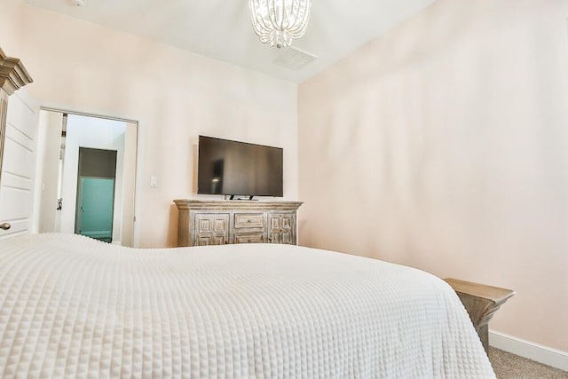 bedroom featuring a chandelier, carpet, and baseboards