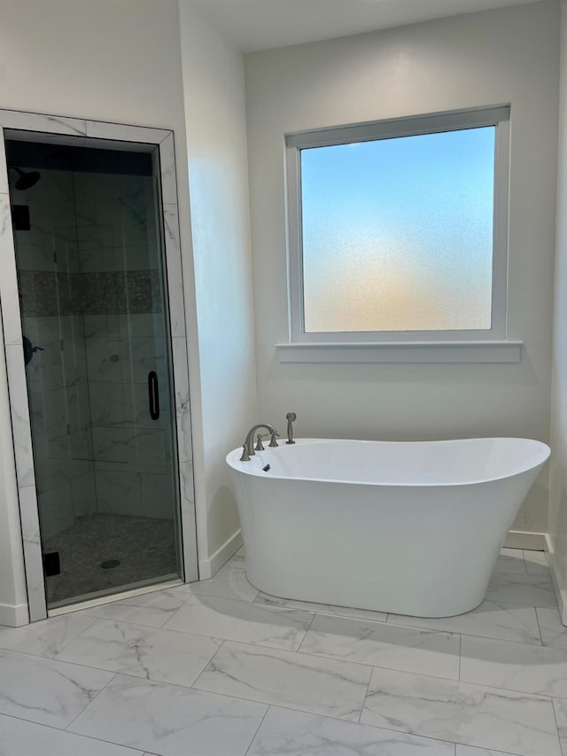 bathroom with shower with separate bathtub