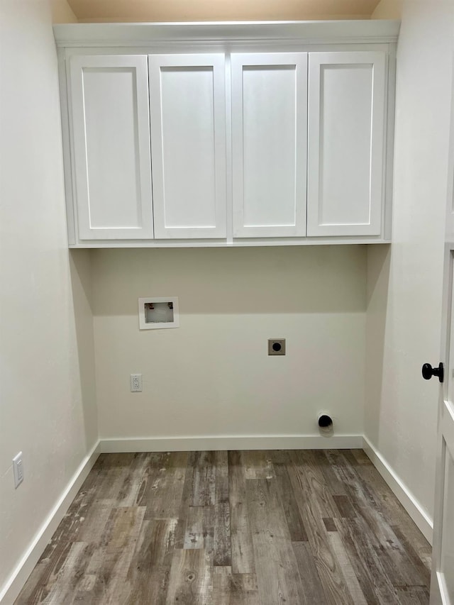 clothes washing area featuring cabinets, wood-type flooring, hookup for a washing machine, and electric dryer hookup