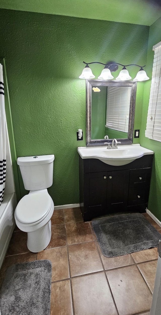 full bath with tile patterned floors, toilet, vanity, and baseboards