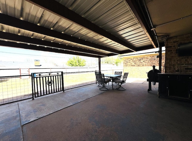 view of patio featuring fence and outdoor dining space