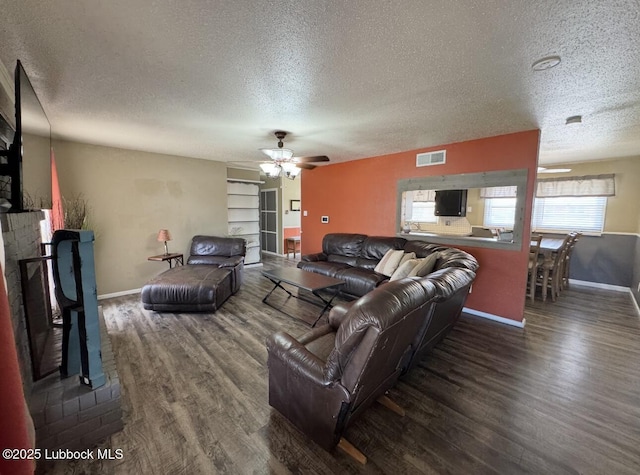 5442 14th St, Lubbock, TX 79416 - living room with a textured ceiling, wood finished floors, baseboards, and a ceiling fan