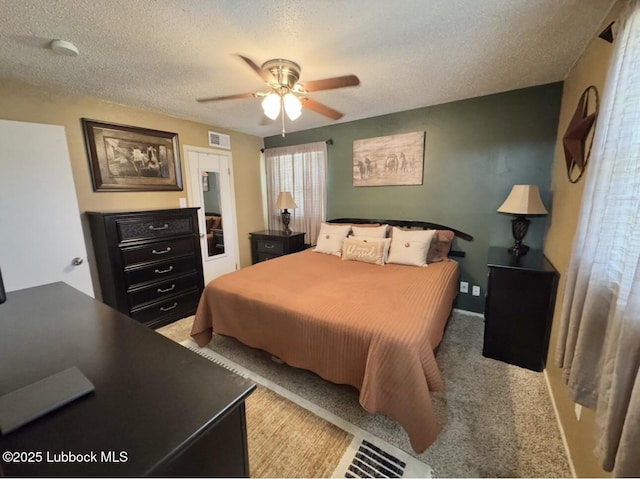 5442 14th St, Lubbock, TX 79416 - bedroom featuring a textured ceiling, light colored carpet, and a ceiling fan