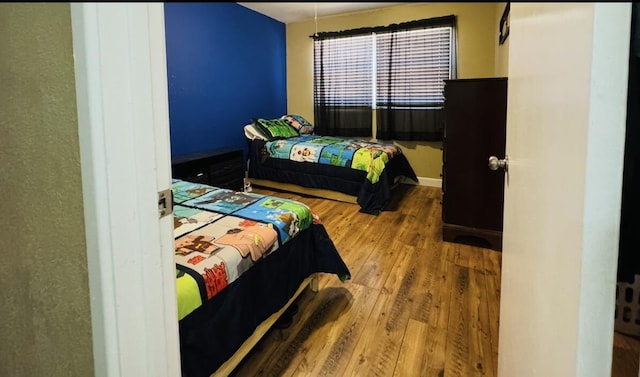 bedroom with wood finished floors