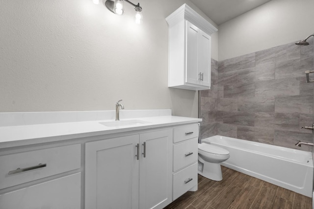 bathroom with bathing tub / shower combination, toilet, wood finished floors, and vanity