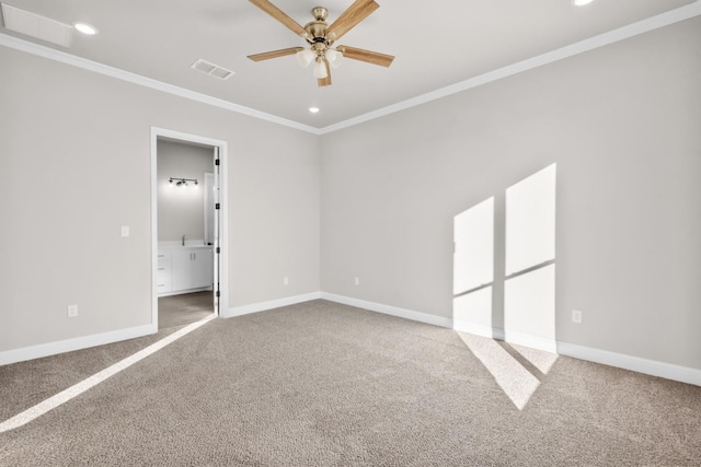 carpeted empty room featuring visible vents, ceiling fan, crown molding, and baseboards