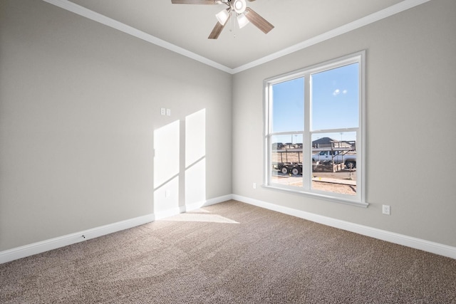 empty room featuring ceiling fan, baseboards, carpet, and ornamental molding