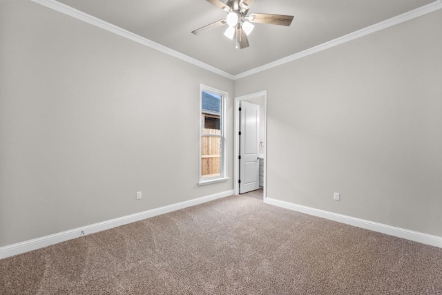 carpeted empty room with ornamental molding and ceiling fan