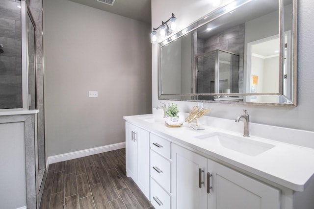 bathroom featuring a sink, baseboards, a stall shower, and wood tiled floor