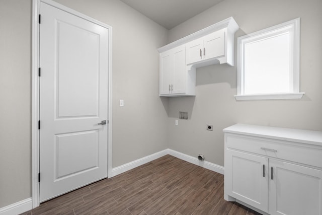 clothes washing area with washer hookup, cabinets, dark hardwood / wood-style floors, and hookup for an electric dryer