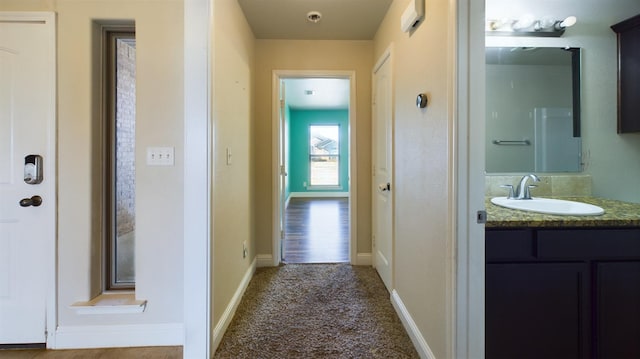 hall featuring carpet floors and sink