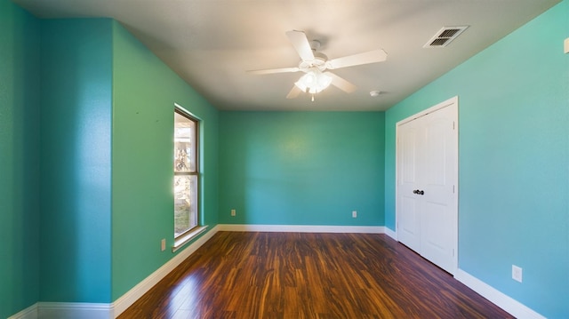 interior space featuring dark wood-type flooring and ceiling fan