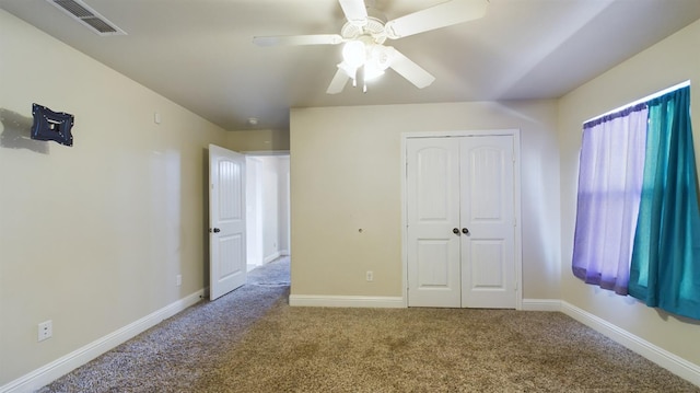 unfurnished bedroom with ceiling fan, carpet floors, and a closet