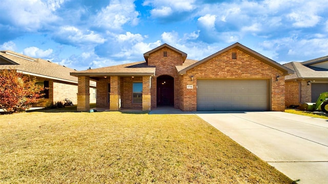 view of front of home featuring a garage and a front lawn