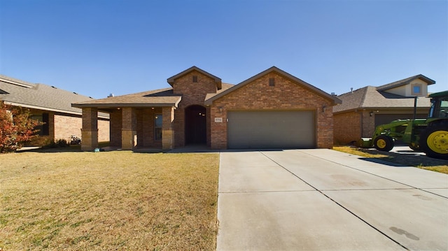 view of front of home featuring a garage and a front yard