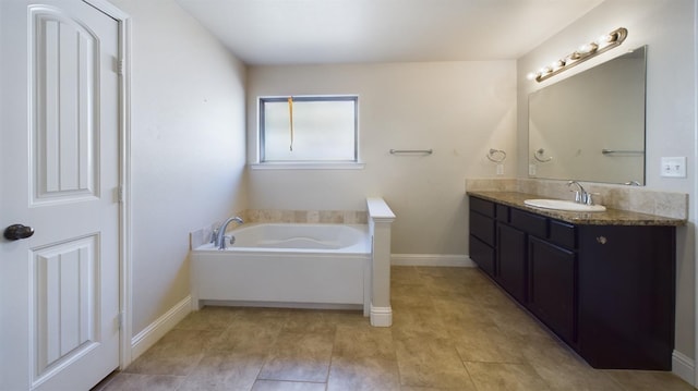 bathroom featuring a tub to relax in and vanity