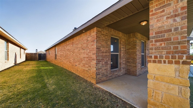 view of home's exterior with a yard and a patio area