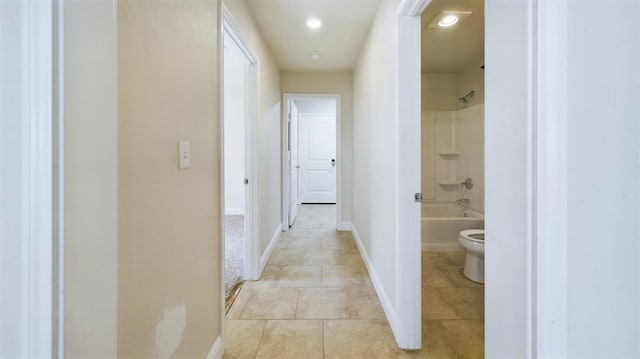 hall featuring light tile patterned flooring