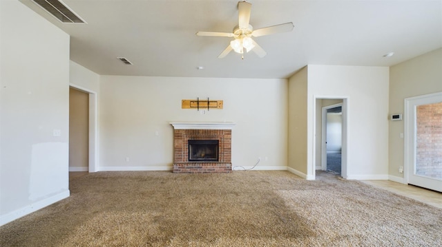 unfurnished living room with ceiling fan, light carpet, and a brick fireplace