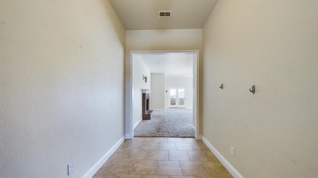 corridor featuring light tile patterned floors