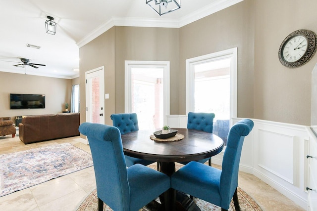 3709 156th St, Lubbock, TX 79423 - dining space with ornamental molding, a ceiling fan, a wainscoted wall, a decorative wall, and light tile patterned flooring