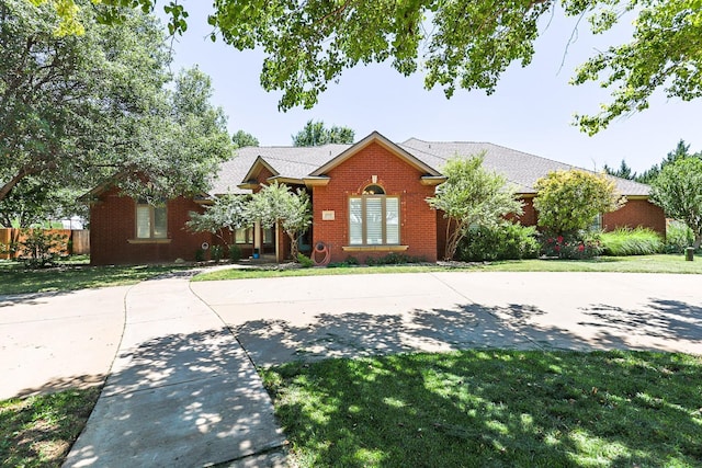 3709 156th St, Lubbock, TX 79423 - view of front of house featuring brick siding and curved driveway