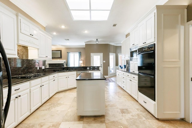3709 156th St, Lubbock, TX 79423 - kitchen with appliances with stainless steel finishes, a peninsula, dark countertops, crown molding, and tasteful backsplash
