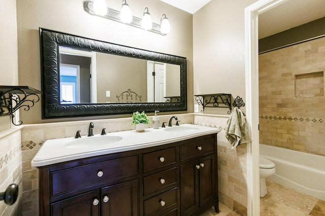 3709 156th St, Lubbock, TX 79423 - full bath with tile walls, double vanity, wainscoting, shower / tub combination, and tile patterned flooring