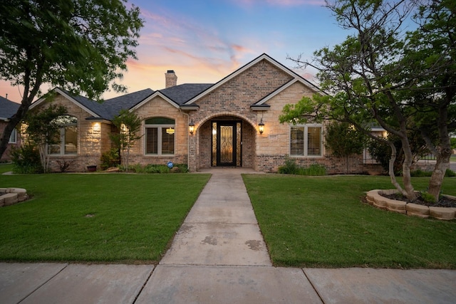 view of front of property with a yard