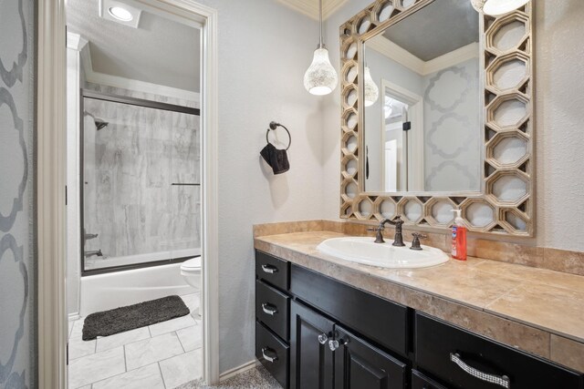 full bathroom featuring tile patterned floors, toilet, bath / shower combo with glass door, ornamental molding, and vanity