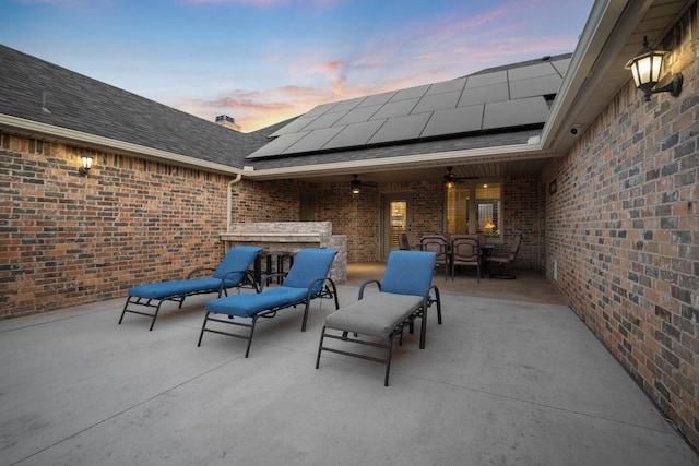 patio terrace at dusk featuring ceiling fan