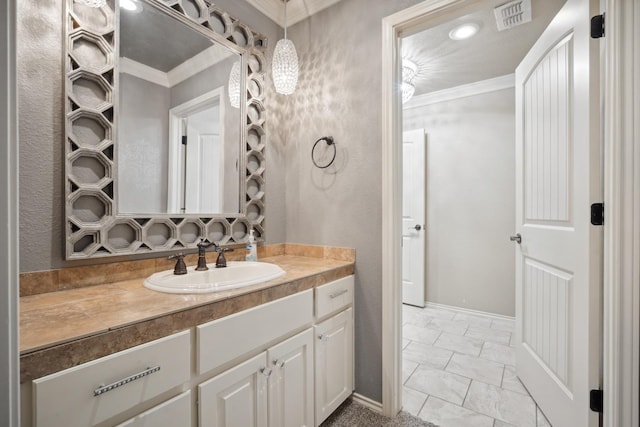 bathroom featuring crown molding and vanity