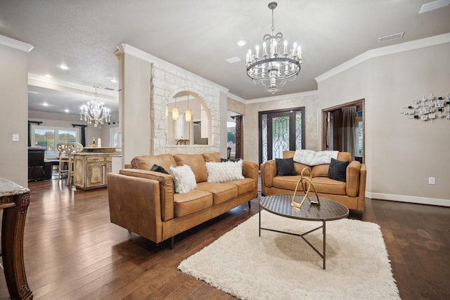 living room with dark wood-type flooring, crown molding, and a chandelier