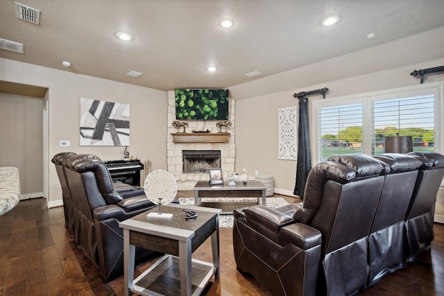 living room featuring dark hardwood / wood-style floors and a fireplace