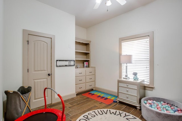 bedroom with wood finished floors and baseboards