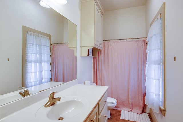 bathroom with tile patterned floors, vanity, toilet, and curtained shower