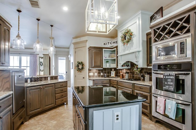 kitchen featuring a sink, stainless steel appliances, crown molding, visible vents, and backsplash