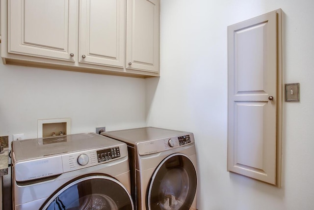 washroom with separate washer and dryer and cabinet space