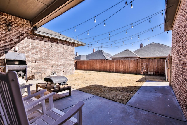 view of patio / terrace with grilling area and a fenced backyard